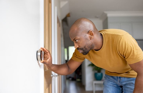 man turning off thermostat