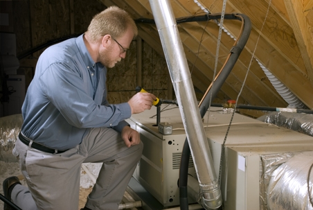 man inspecting furnace system